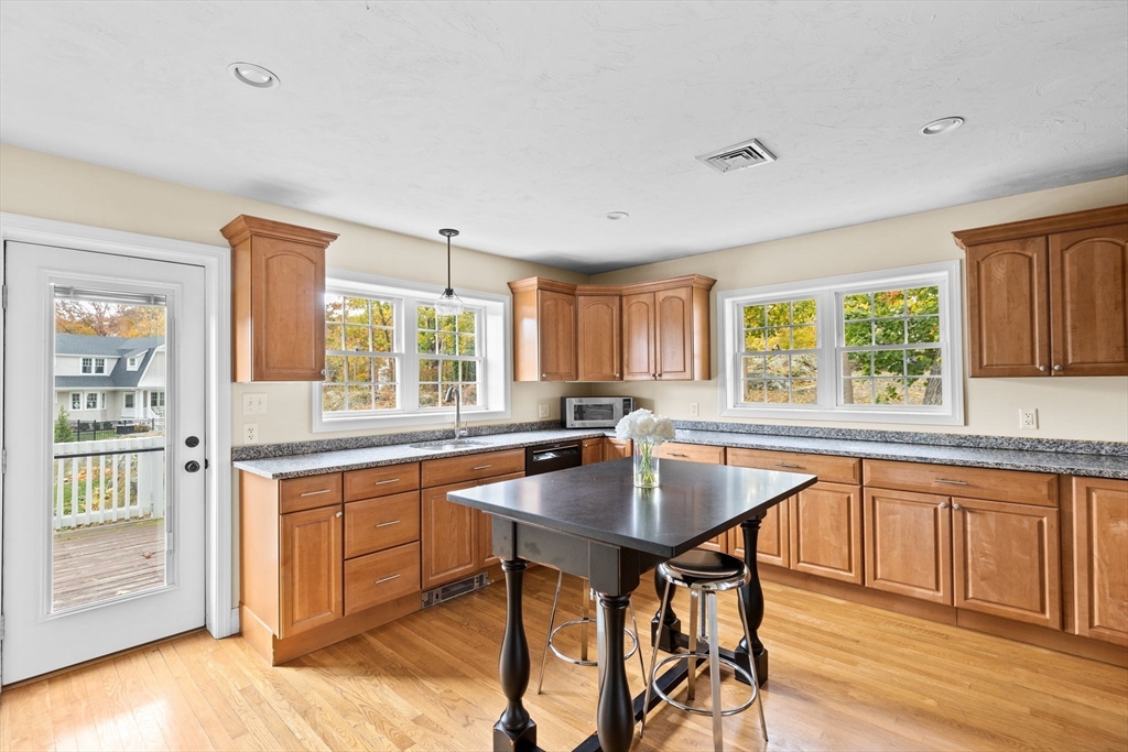 8 Hayes Road Hingham, MA 02043 - Photo 4 of 25 a kitchen with a table chairs sink and cabinets