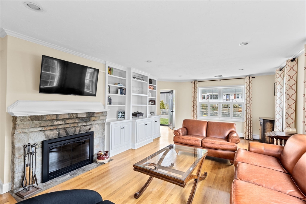 8 Hayes Road Hingham, MA 02043 - Photo 6 of 25 a living room with furniture a fireplace and a flat screen tv