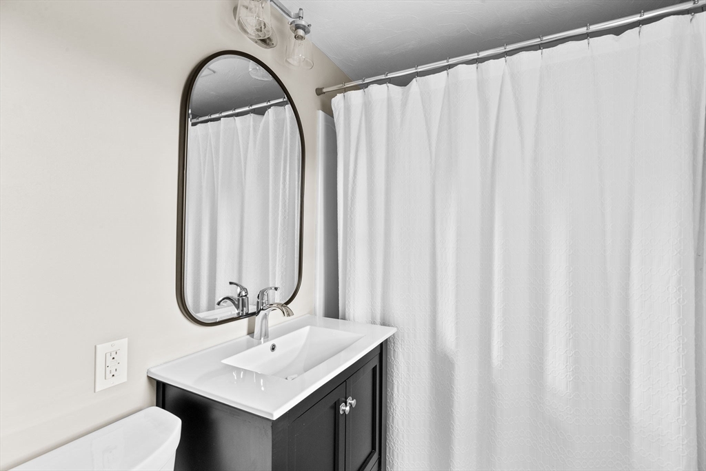 8 Hayes Road Hingham, MA 02043 - Photo 9 of 25 a bathroom with a sink and a mirror