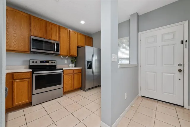 a kitchen with stainless steel appliances granite countertop a refrigerator and a stove top oven
