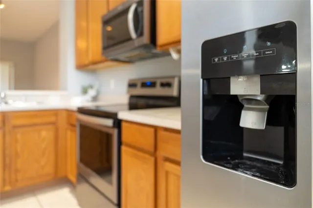 a kitchen with stainless steel appliances granite countertop a refrigerator and a sink