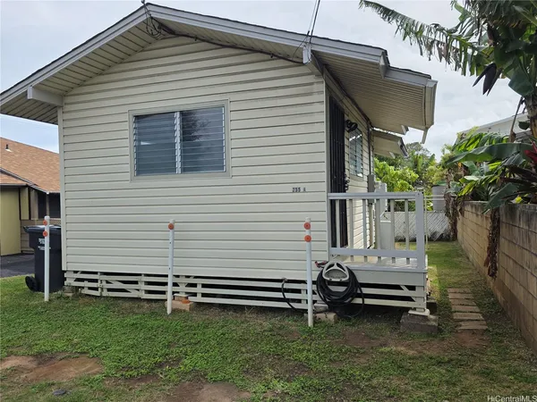 a backyard of a house with table and chairs