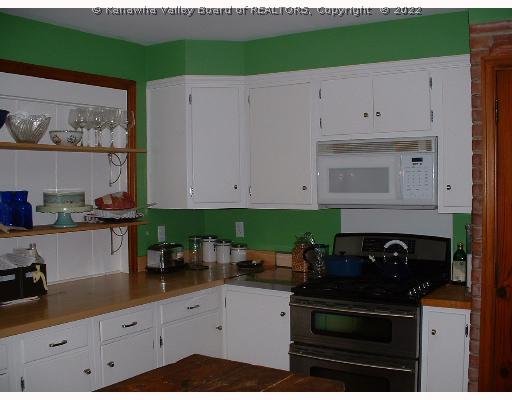 Kitchen. Updated kitchen with gas stove, maple counters and imported tile floor.