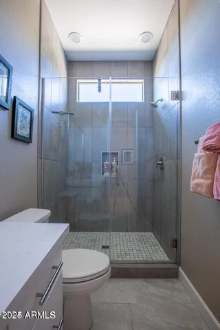 a bathroom with a shower a toilet and a sink
