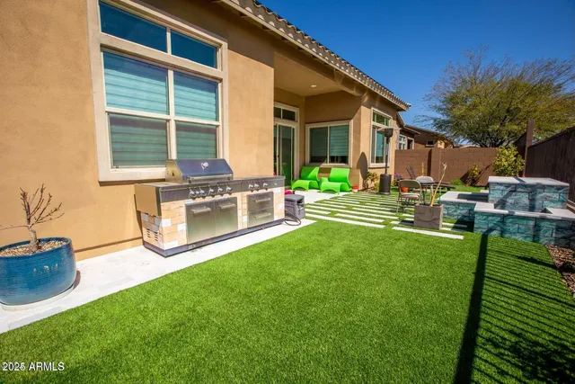 a house view with a sitting space and garden