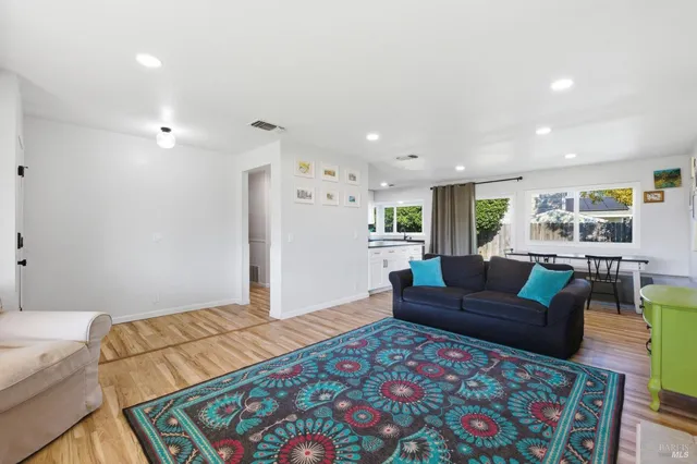 a bedroom with furniture and a wooden floor
