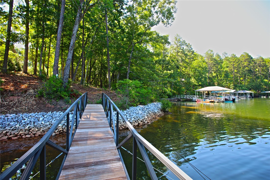 1359 Hbr Rdg Road Seneca, SC 29672 - Photo 28 of 39 A tranquil lakefront property featuring a private dock and mature tree-lined shores.