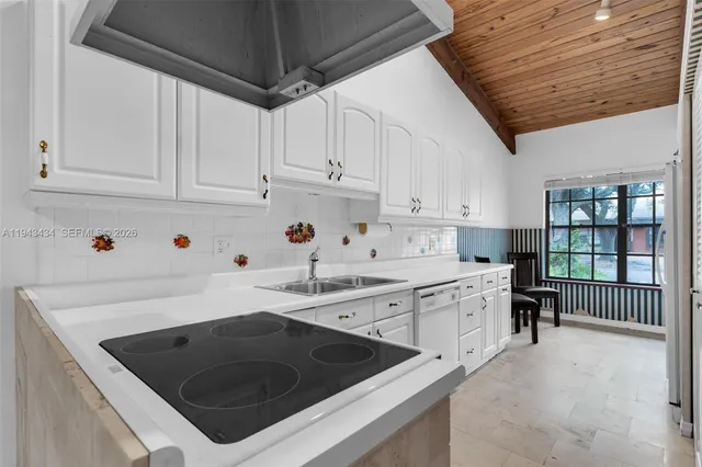 a view of a hallway to a house with a ceiling fan