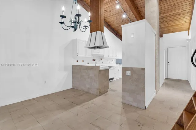 an empty room with large window and doors