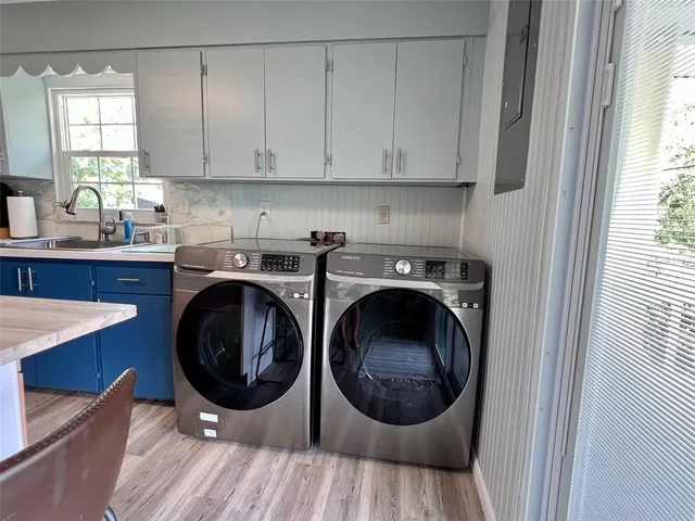 a kitchen with a washer and dryer in it