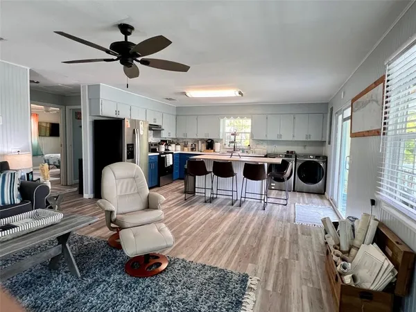 a living room with furniture a rug and a chandelier