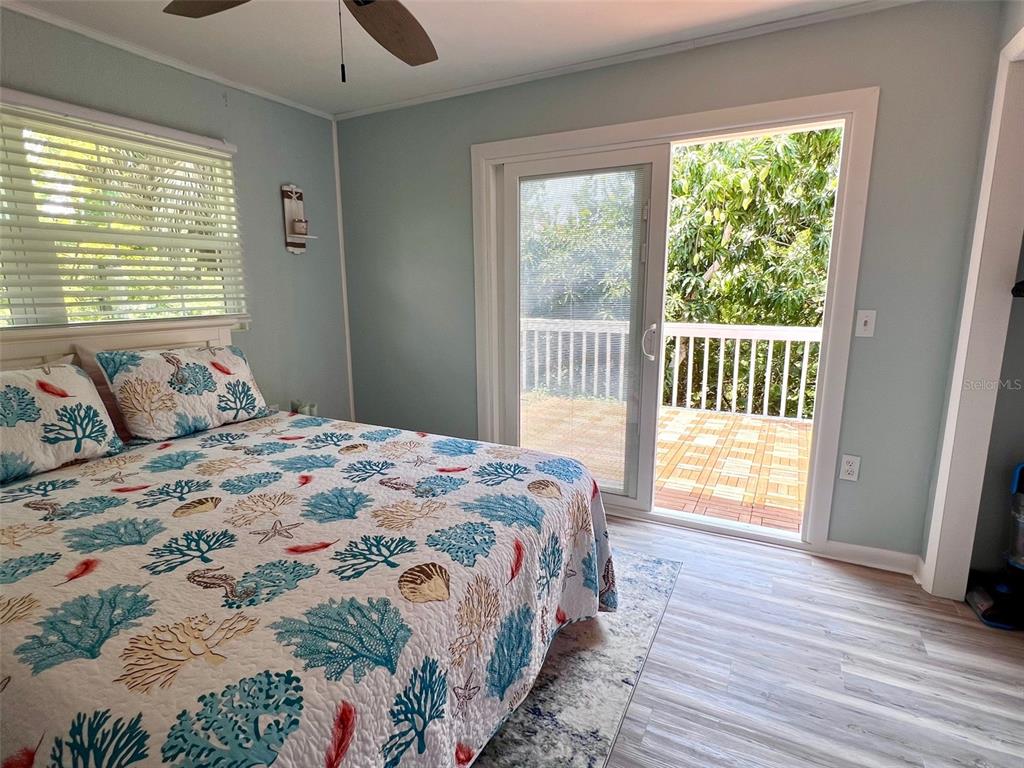8142 Little Gasparilla Placida, FL 33946 - Photo 22 of 38 a bedroom with a large bed and a window