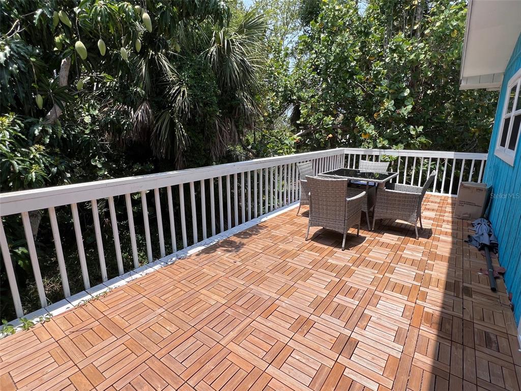 8142 Little Gasparilla Placida, FL 33946 - Photo 23 of 38 a roof deck with a wooden fence and floor
