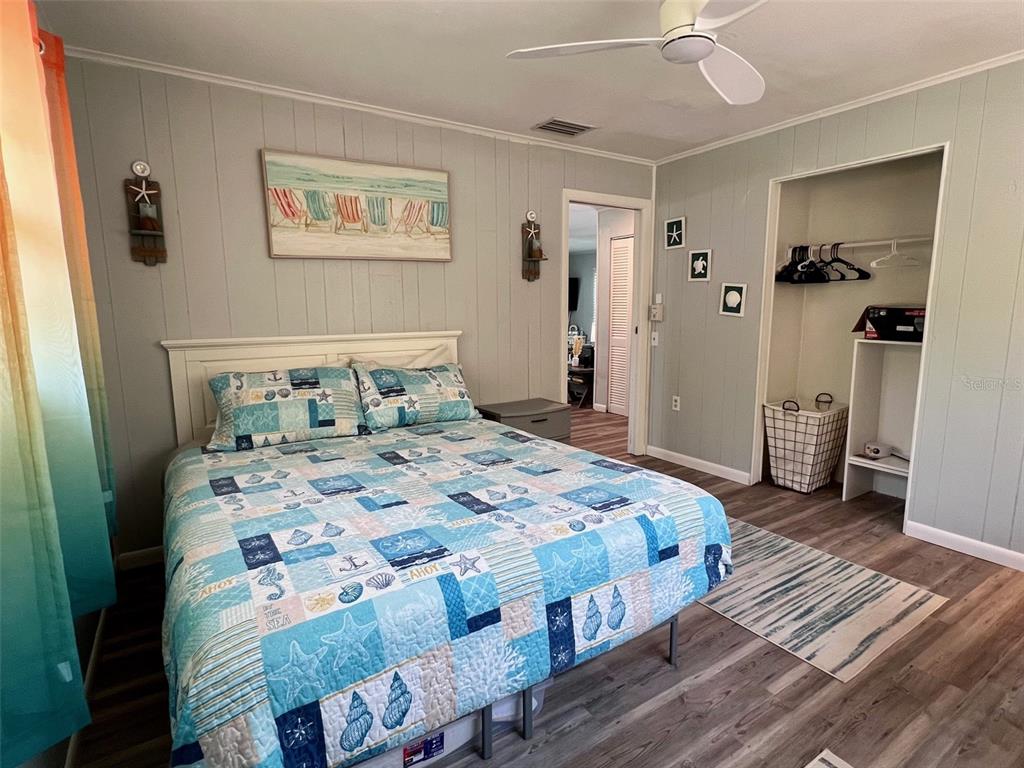 8142 Little Gasparilla Placida, FL 33946 - Photo 26 of 38 a bedroom with a bed and wooden floor