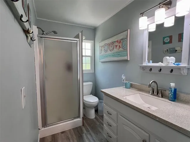 a bathroom with a sink a toilet and shower