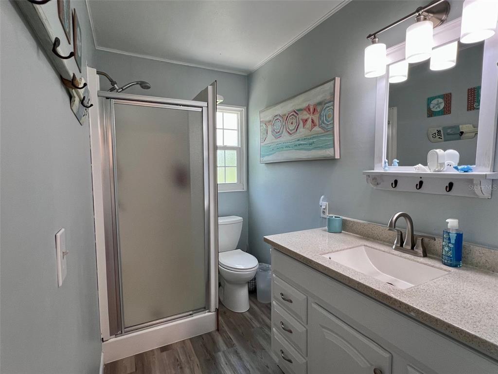 8142 Little Gasparilla Placida, FL 33946 - Photo 27 of 38 a bathroom with a sink a toilet and shower