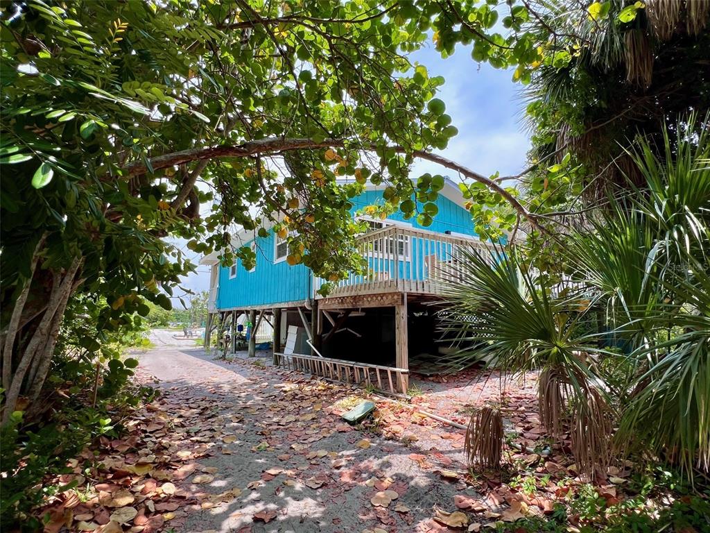 8142 Little Gasparilla Placida, FL 33946 - Photo 8 of 38 a view of a chair and table under an umbrella
