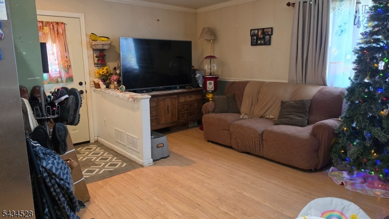 1115 West Camplain Road Manville, NJ 08835 - Photo 8 of 18 a living room with furniture and a flat screen tv