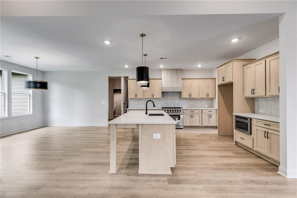 728 Lake Cir Road Buchanan, GA 30113 - Photo 12 of 50 a large kitchen with stainless steel appliances granite countertop a stove top oven a sink and a refrigerator