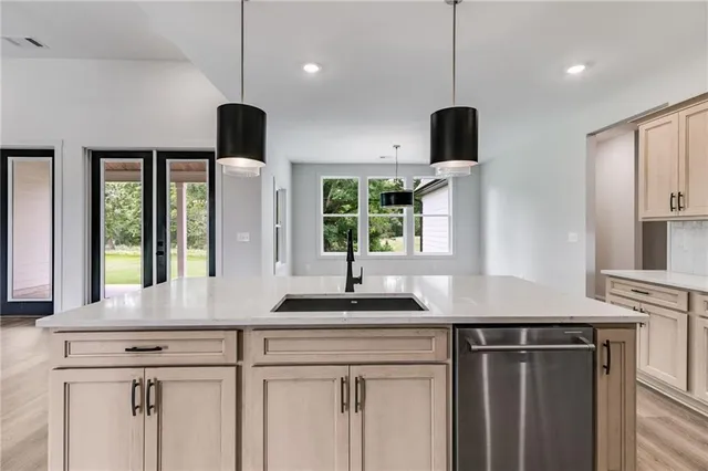 a kitchen with a sink and large window