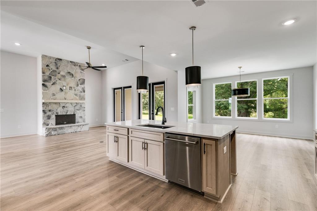 728 Lake Cir Road Buchanan, GA 30113 - Photo 19 of 50 a large kitchen with stainless steel appliances granite countertop a stove and a wooden floors