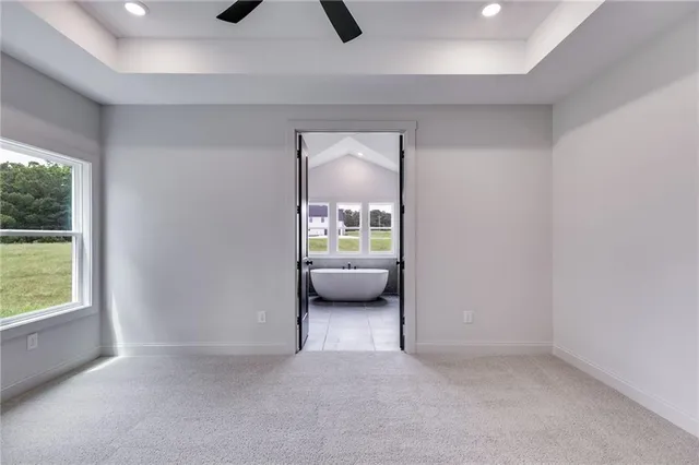 a spacious bathroom with a double vanity sink a mirror and a bathtub