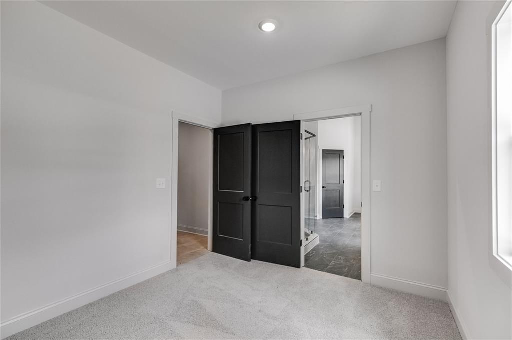 728 Lake Cir Road Buchanan, GA 30113 - Photo 27 of 50 an empty room with closet and wooden door