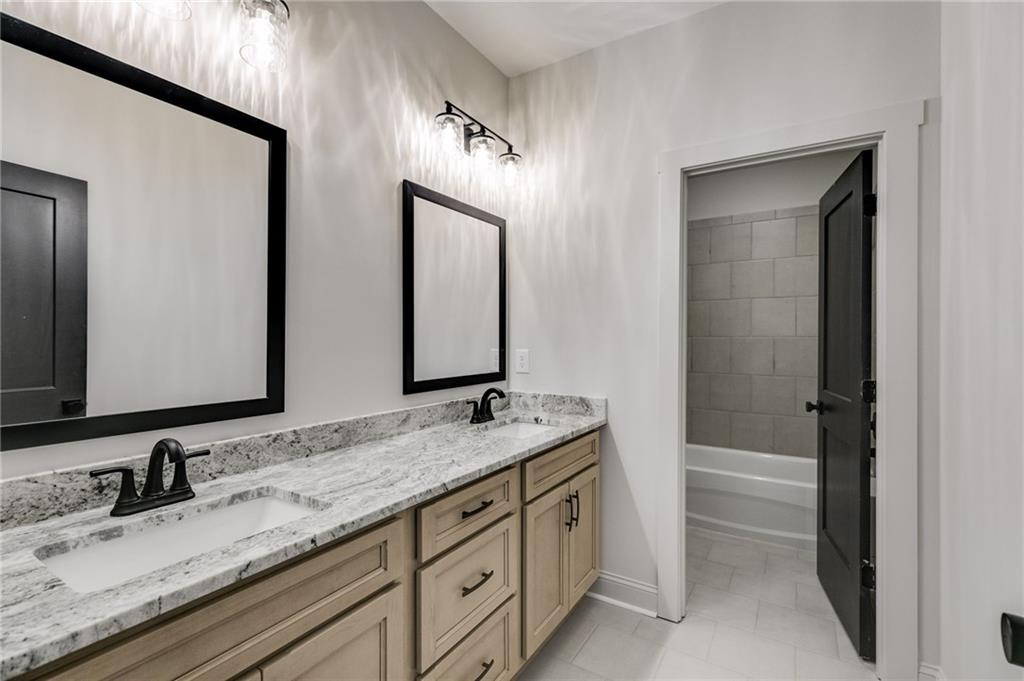728 Lake Cir Road Buchanan, GA 30113 - Photo 30 of 50 a bathroom with a granite countertop sink double and mirror