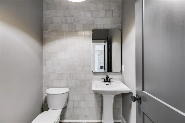 a view of an empty room with a window and kitchen