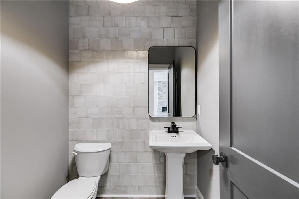 728 Lake Cir Road Buchanan, GA 30113 - Photo 34 of 50 a bathroom with a toilet sink and mirror