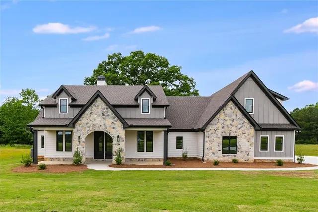 a front view of a house with garden