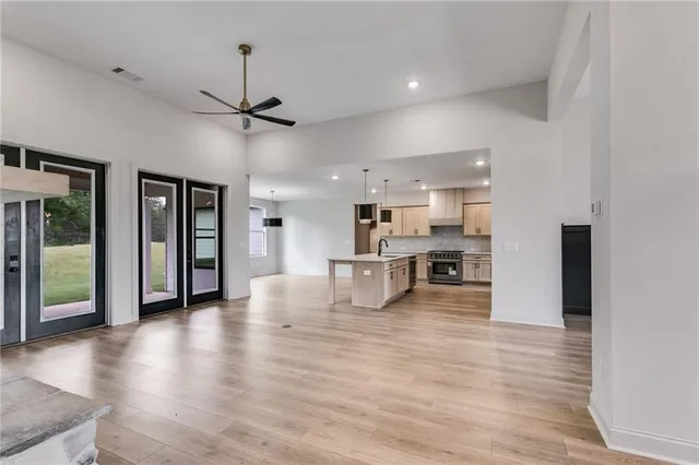a view of a kitchen with furniture and wooden floor