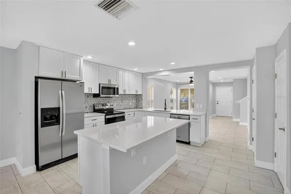 a kitchen with a sink stove and microwave