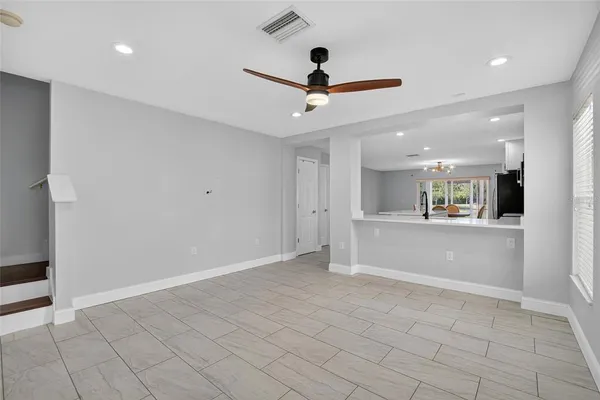 an entryway and a ceiling fan in a room