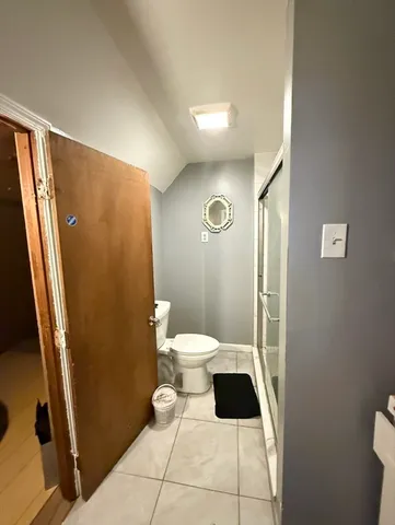 a bathroom with a toilet and a shower