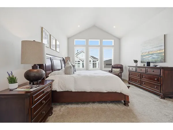 a spacious bedroom with a bed and window