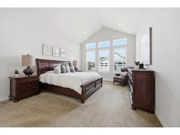 a bed room with a bed and a large window