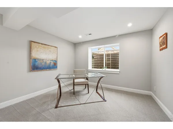 a dining room with a wooden table and chairs