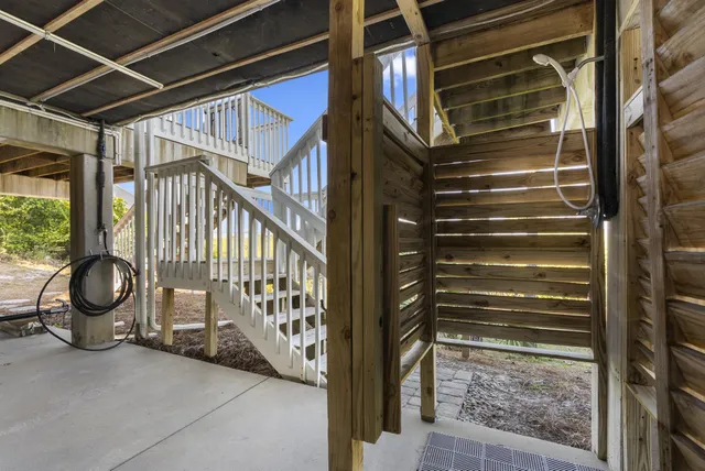 a living room with furniture and a dining table with wooden floor