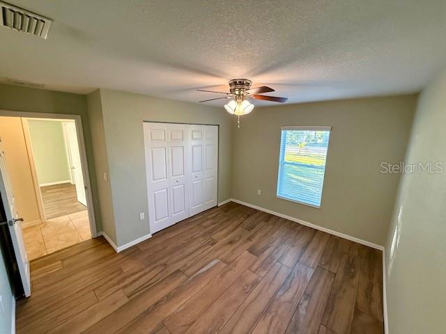 305 East Grace Street Punta Gorda, FL 33950 - Photo 8 of 14 an empty room with wooden floor and window