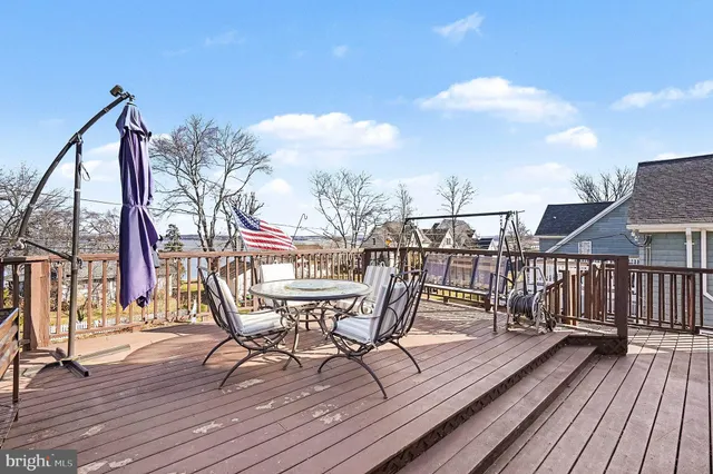 a view of a roof deck with table and chairs