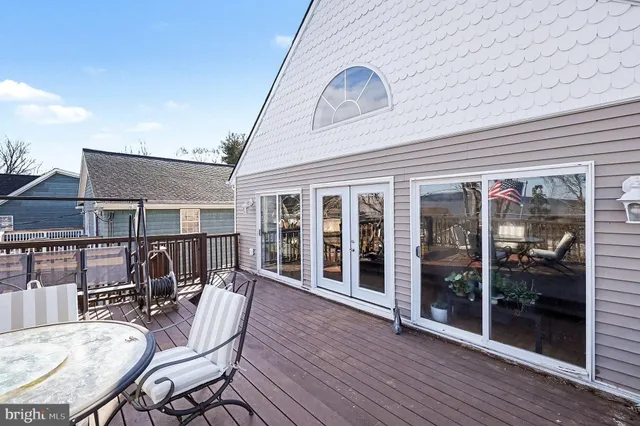 a view of a patio with table and chairs and wooden floor