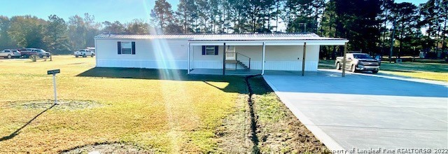 1977 Phillips Road Dunn, NC 28334 - Photo 1 of 22 a swimming pool with outdoor seating and yard