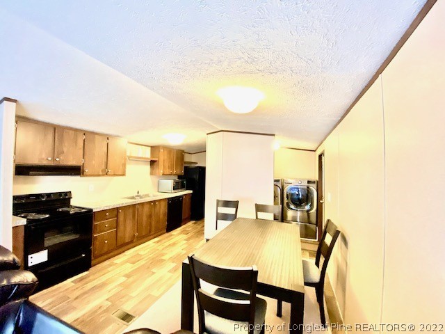 1977 Phillips Road Dunn, NC 28334 - Photo 6 of 22 a kitchen with a table chairs and a refrigerator