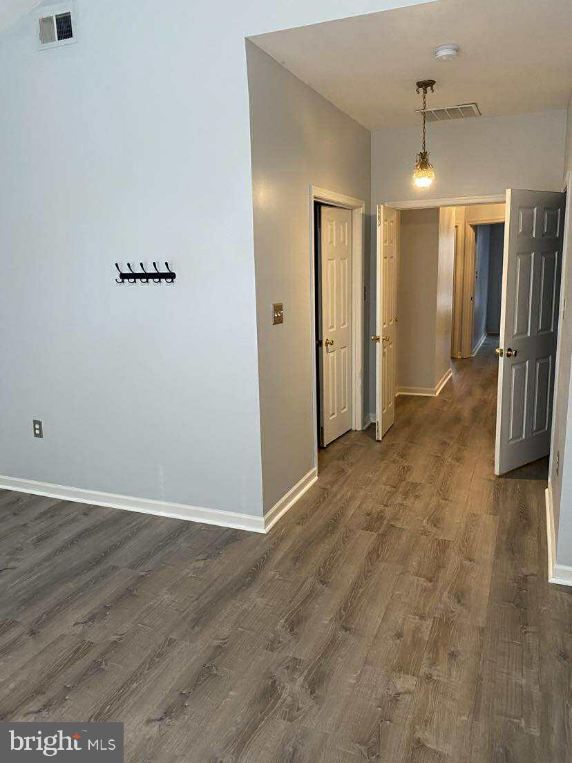 94 Eldon Drive Charles Town, WV 25414 - Photo 20 of 24 an empty room with wooden floor and a ceiling fan