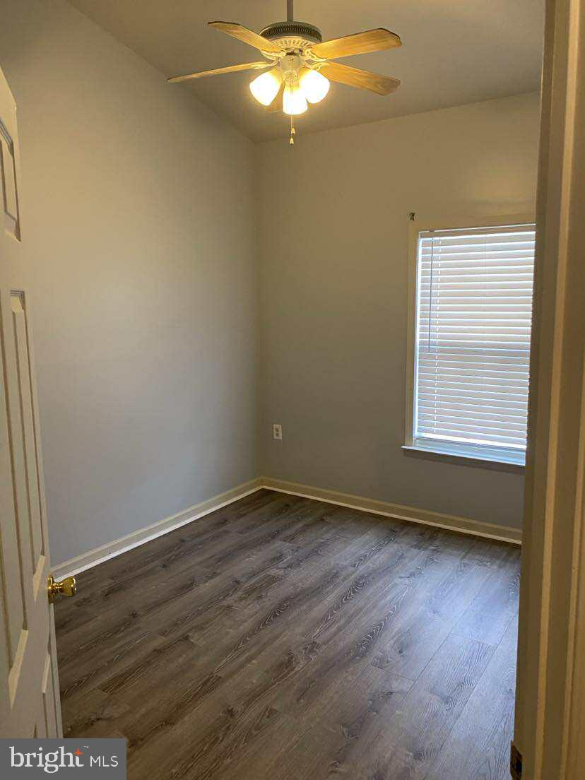 94 Eldon Drive Charles Town, WV 25414 - Photo 22 of 24 a view of an empty room with wooden floor and a window