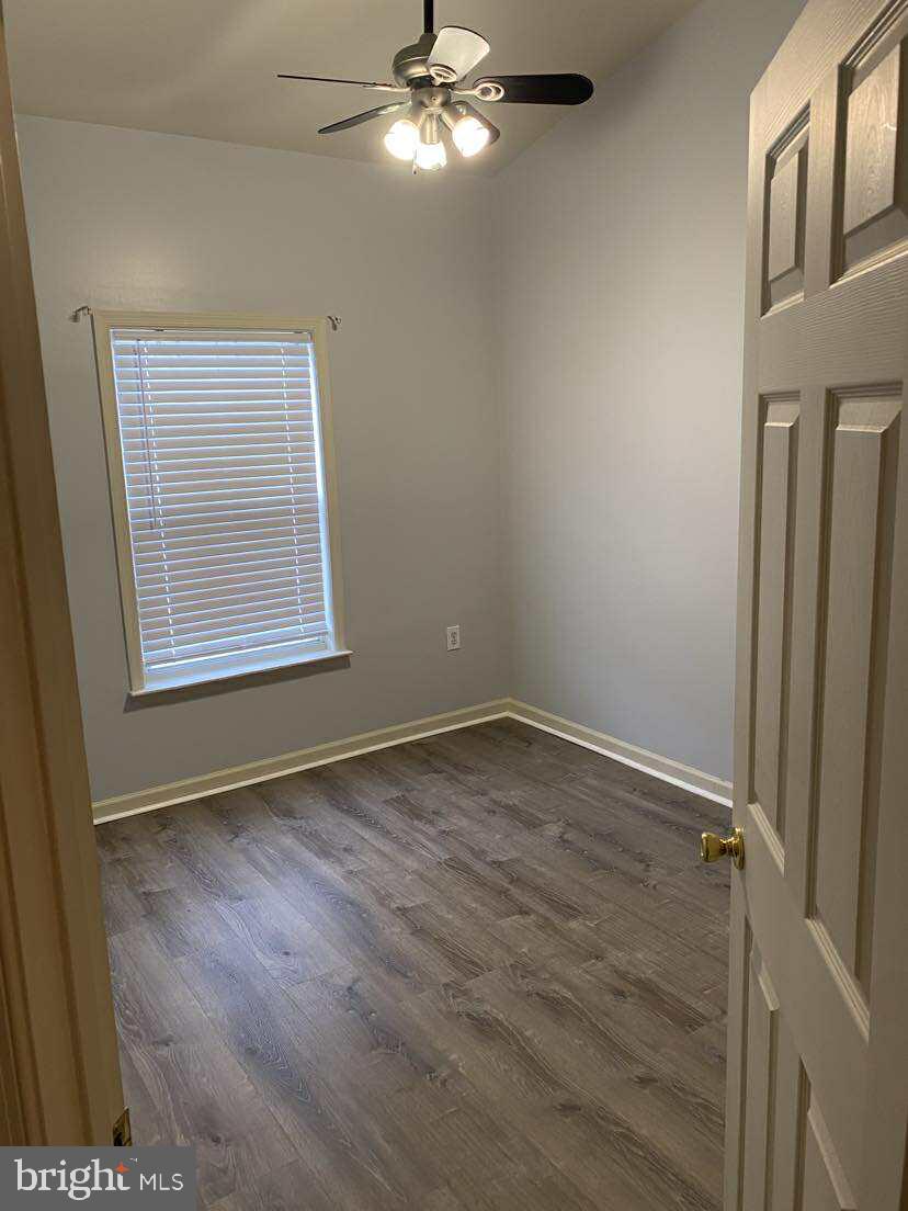 94 Eldon Drive Charles Town, WV 25414 - Photo 23 of 24 a view of an empty room with a window and wooden floor