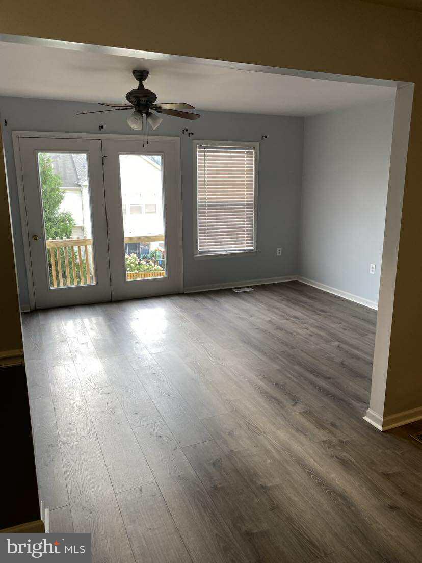 94 Eldon Drive Charles Town, WV 25414 - Photo 10 of 24 a view of an empty room with wooden floor and a window