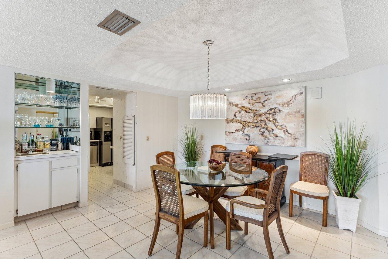 3610 South Ocean Boulevard, Unit 502 South Palm Beach, FL 33480 - Photo 15 of 51 a view of a dining room with furniture window and wooden floor