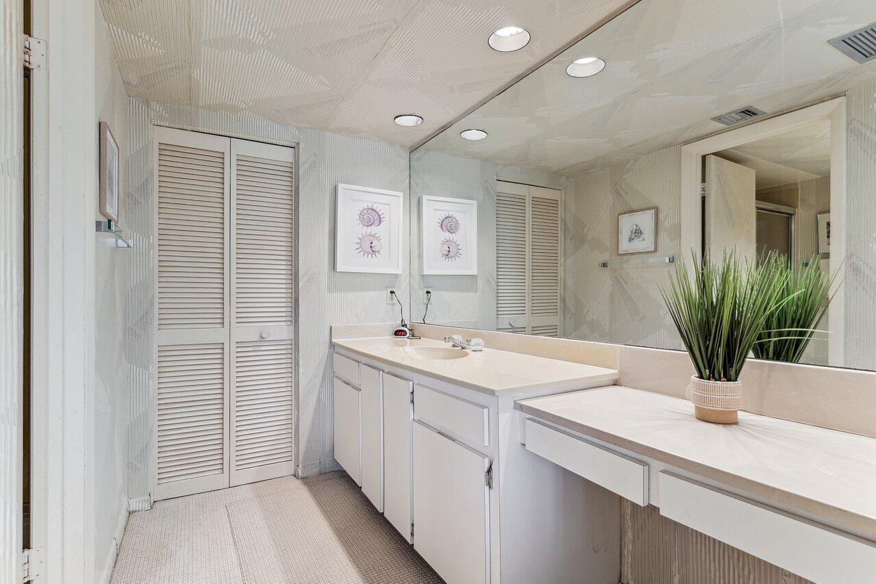 3610 South Ocean Boulevard, Unit 502 South Palm Beach, FL 33480 - Photo 23 of 51 a kitchen with a sink and a mirror